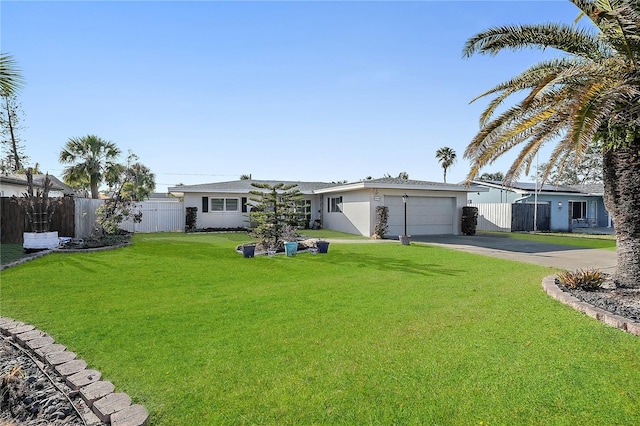 view of front of property with a front yard, fence, a garage, and concrete driveway