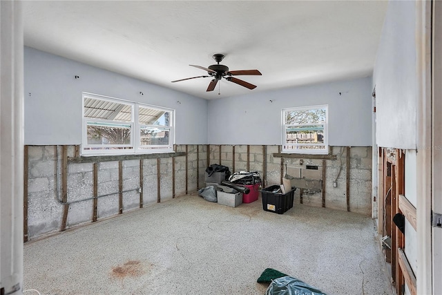 interior space with ceiling fan