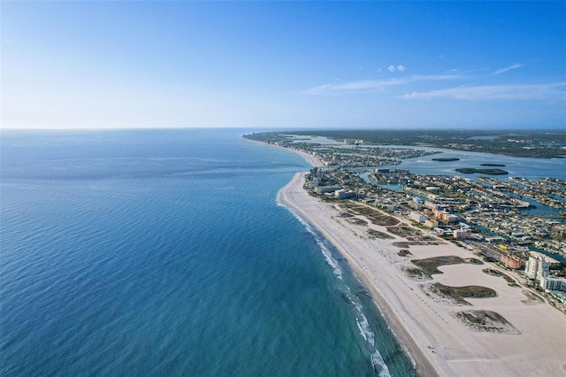 birds eye view of property with a water view and a beach view