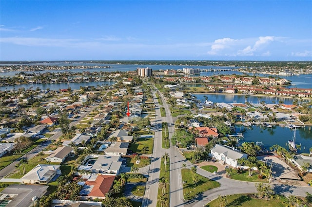 drone / aerial view with a water view and a residential view