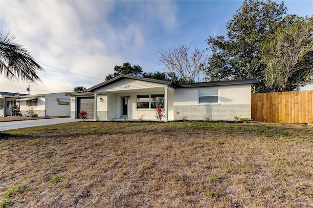 ranch-style home with a garage and a front yard