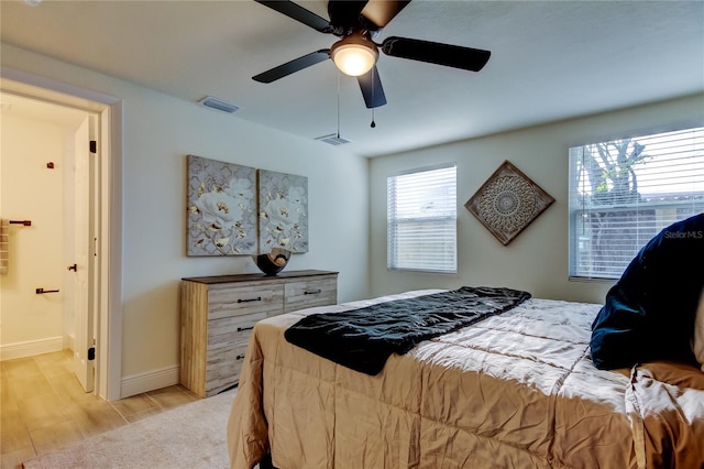 bedroom with ceiling fan and light hardwood / wood-style flooring