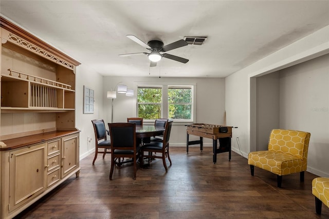 dining space with dark wood-type flooring and ceiling fan