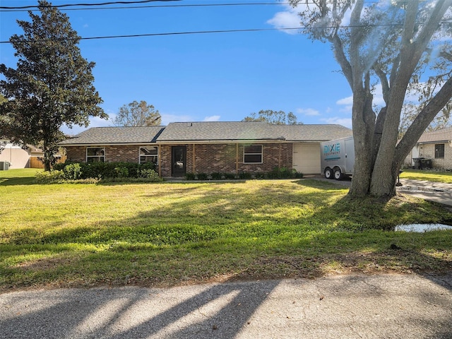 single story home featuring a garage and a front yard