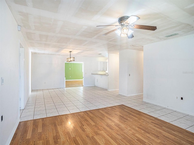 tiled empty room with ceiling fan