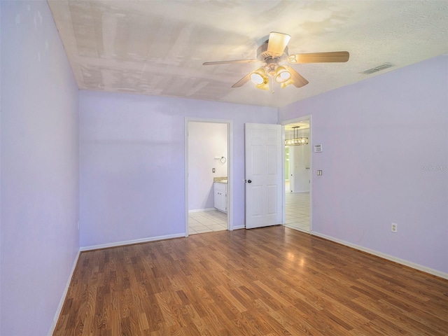 spare room featuring hardwood / wood-style flooring and ceiling fan