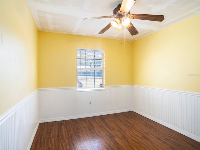 unfurnished room featuring dark wood-type flooring and ceiling fan