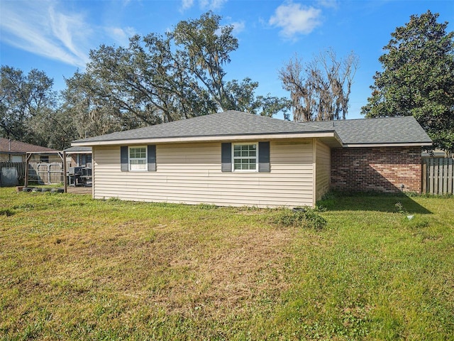 view of side of property with a yard