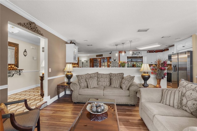 living room featuring wood-type flooring and ornamental molding