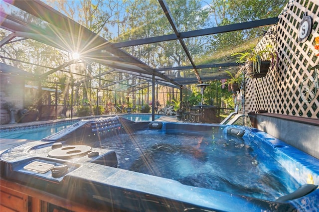 view of pool with a lanai and a hot tub