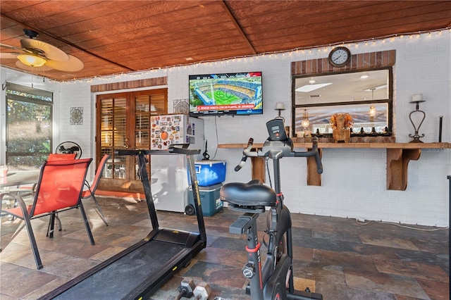 exercise area with brick wall and wooden ceiling