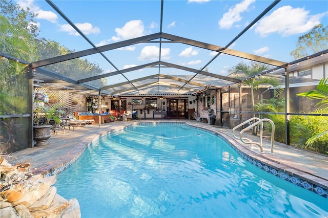 view of swimming pool featuring a jacuzzi, a patio area, and glass enclosure