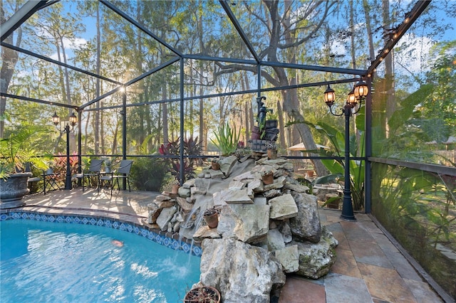 view of swimming pool with a patio area and glass enclosure