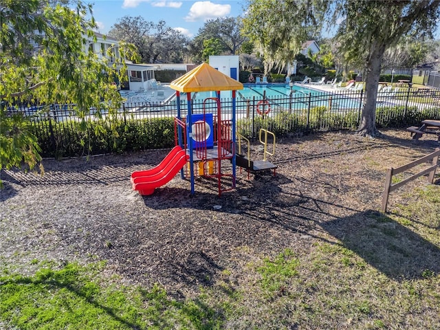 view of jungle gym with a community pool