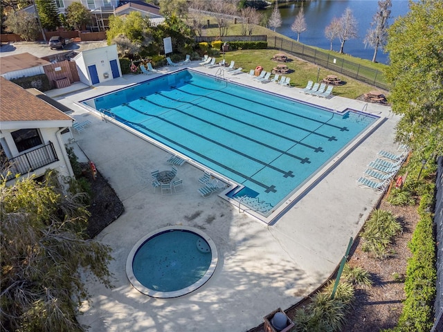 view of pool featuring a water view and a patio area