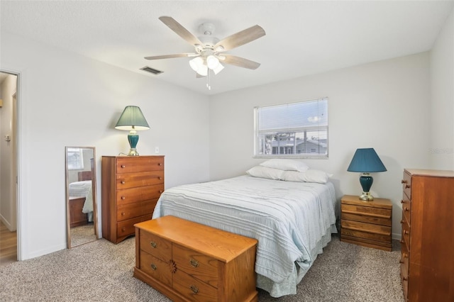 bedroom with ceiling fan and light carpet