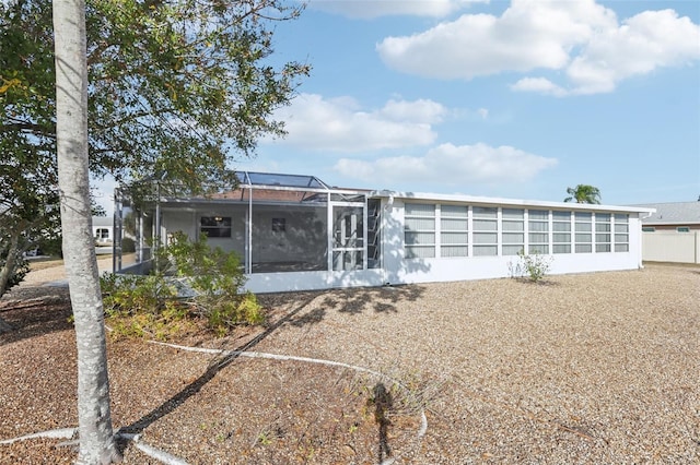 rear view of house featuring a lanai