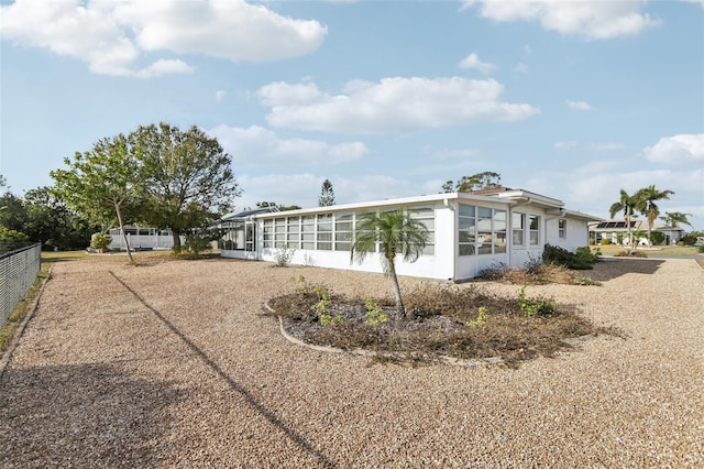 view of home's exterior with a sunroom