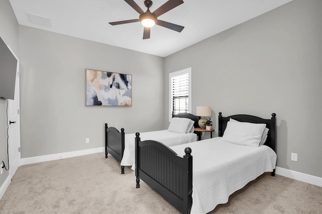 bedroom featuring light carpet and ceiling fan