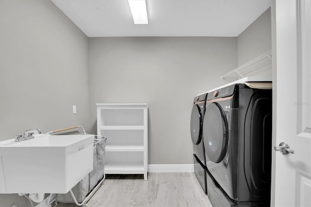 washroom featuring washing machine and clothes dryer and sink