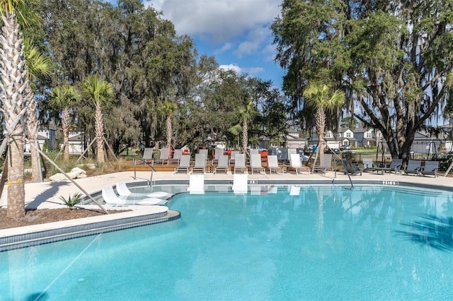 view of swimming pool featuring a patio area