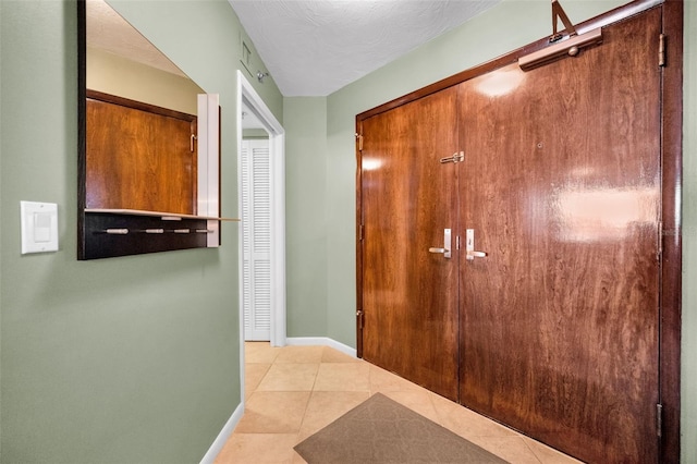 corridor with light tile patterned flooring