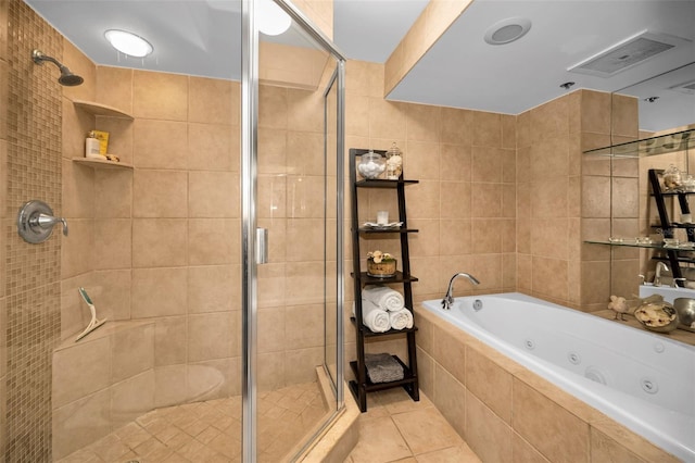 bathroom featuring tile patterned flooring, tile walls, and separate shower and tub