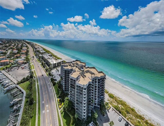 drone / aerial view featuring a water view and a view of the beach