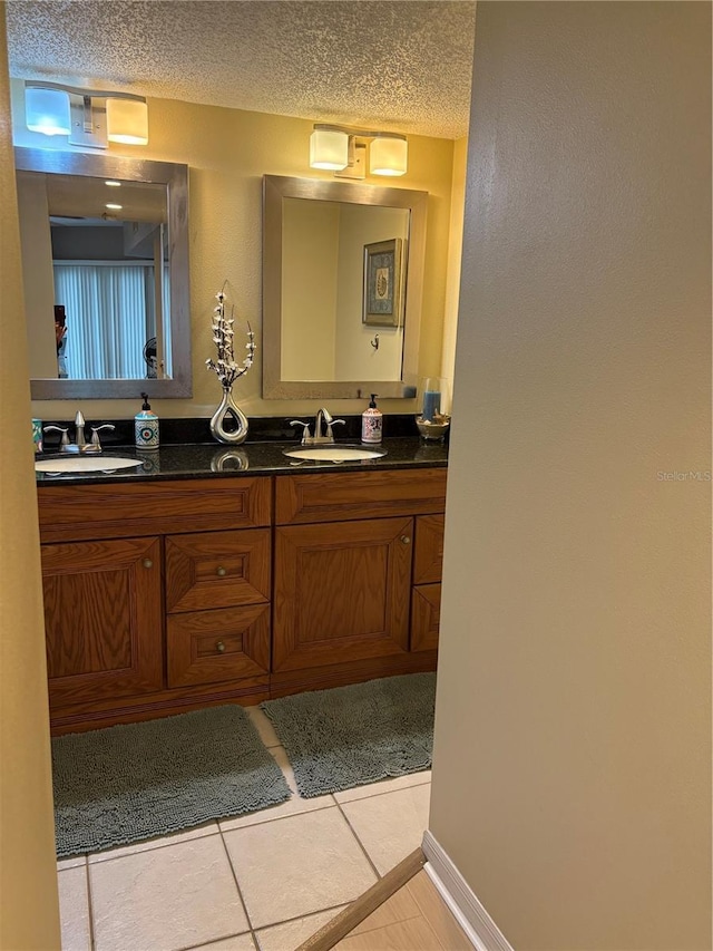 bathroom featuring tile patterned floors, vanity, and a textured ceiling