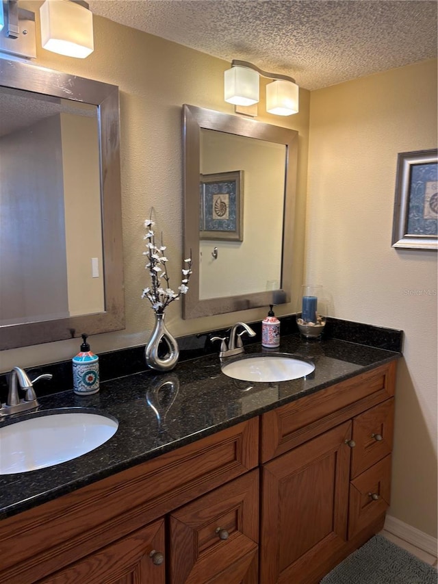 bathroom with vanity and a textured ceiling