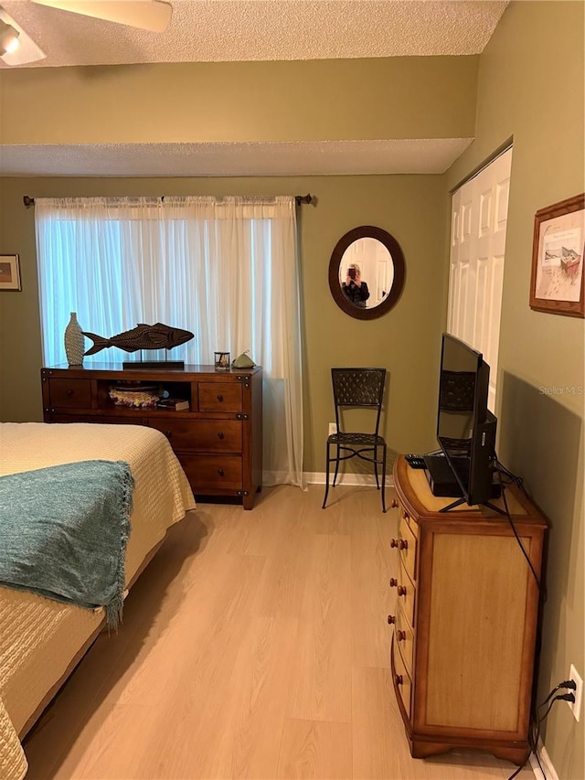 bedroom with wood-type flooring and a textured ceiling