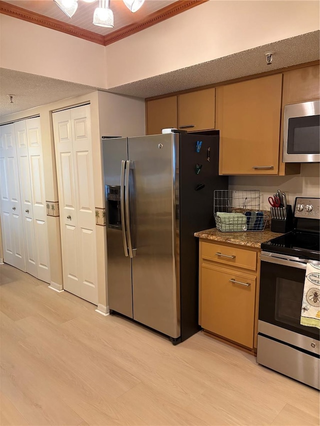 18400 Gulf Blvd Unit 1505, Indian Shores, FL 33785 - kitchen with stainless steel appliances, light wood finished floors, ornamental molding, and stone counters