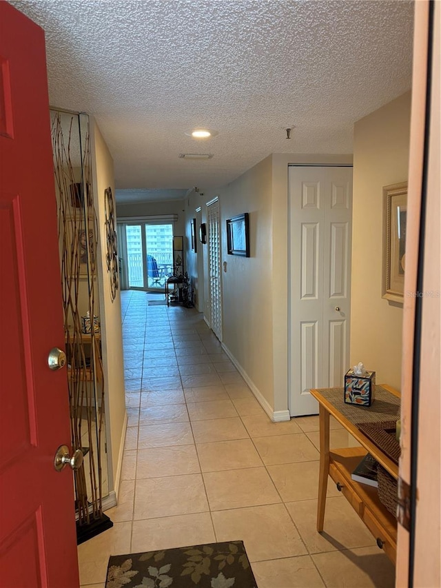 18400 Gulf Blvd Unit 1505, Indian Shores, FL 33785 - hallway featuring light tile patterned floors and a textured ceiling