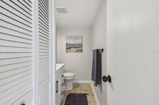 bathroom with vanity, hardwood / wood-style flooring, and toilet