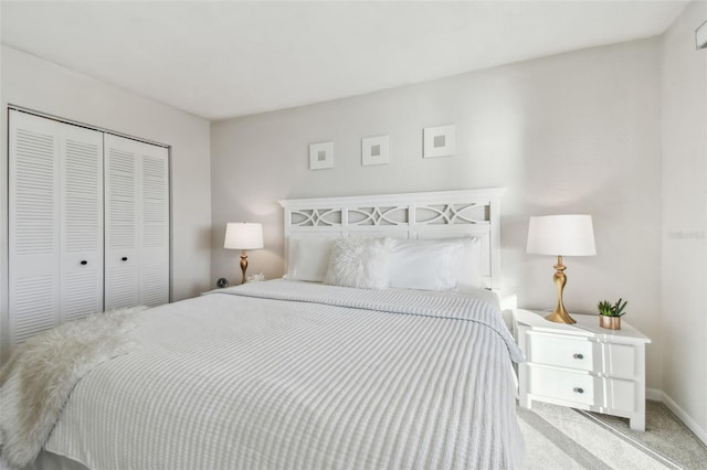 bedroom featuring light colored carpet and a closet