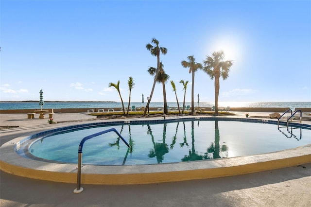 view of pool with a water view