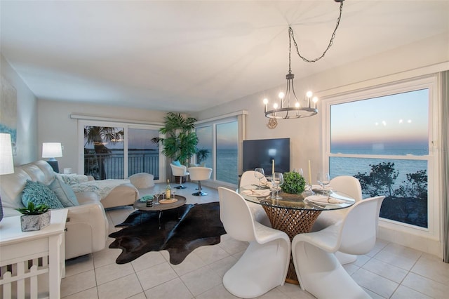 dining space featuring light tile patterned floors and a chandelier