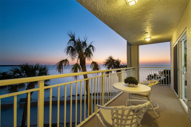 balcony at dusk with a water view