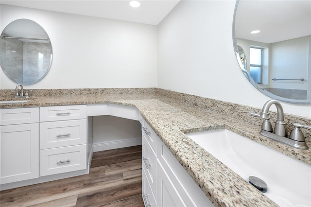 bathroom with wood-type flooring and vanity