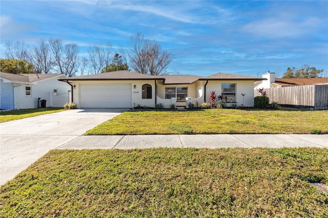 ranch-style home featuring a garage and a front lawn