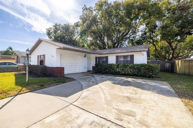 single story home featuring a garage and a front yard