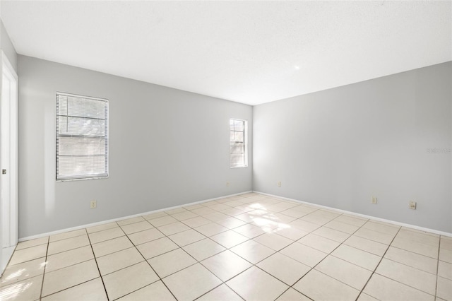 unfurnished room with light tile patterned floors