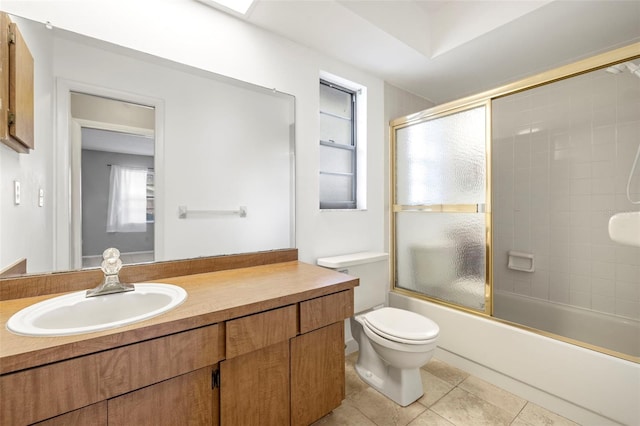 full bathroom featuring tile patterned flooring, vanity, combined bath / shower with glass door, and toilet