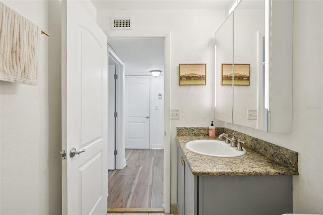 bathroom featuring vanity and hardwood / wood-style floors