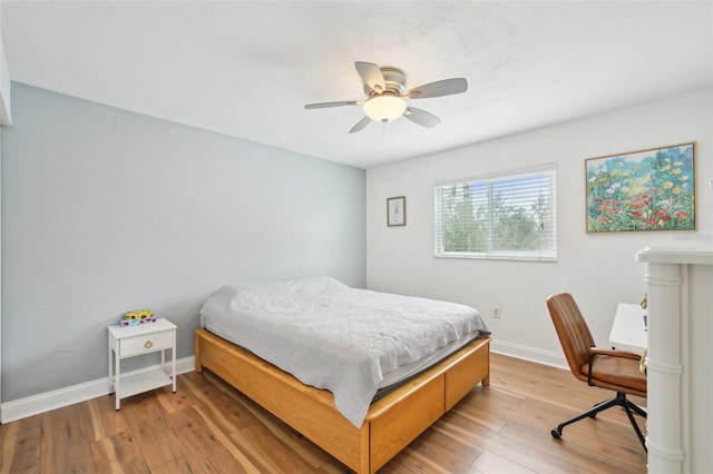 bedroom with ceiling fan and light hardwood / wood-style floors