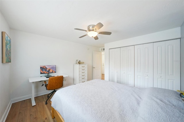 bedroom featuring hardwood / wood-style flooring, ceiling fan, and a closet