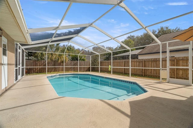 view of swimming pool with a patio and a lanai