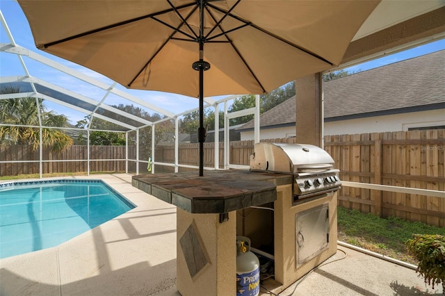 view of swimming pool with area for grilling, a lanai, and a patio area