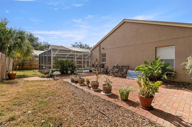 view of yard with a lanai and a patio area