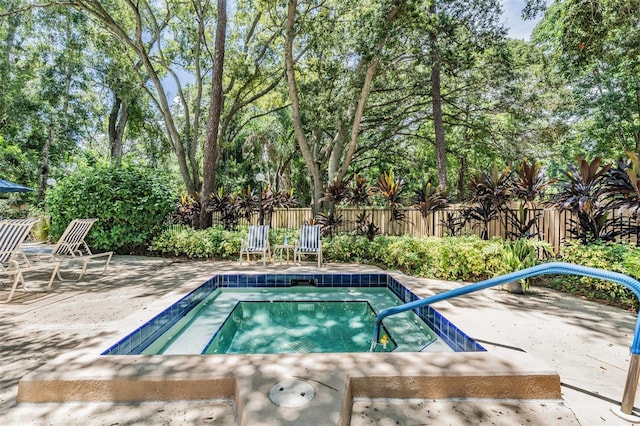 view of pool with a patio area and fence